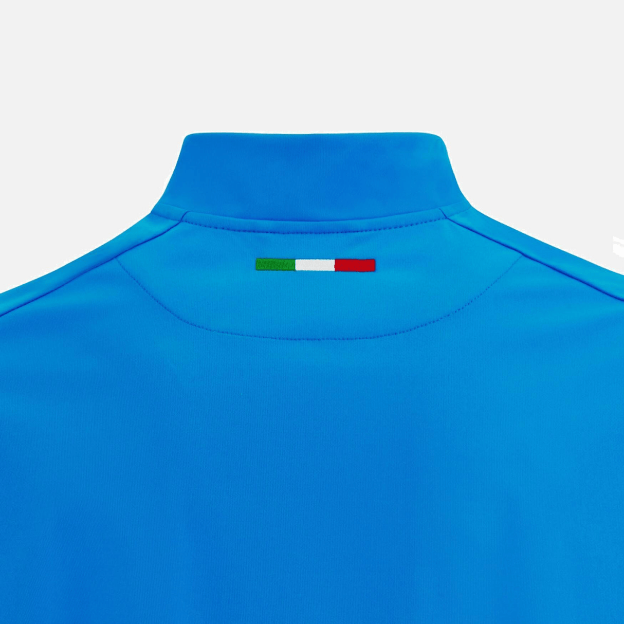 Back view of the Italy Full-Zip Softshell Anthem Jacket 22/23 by Macron, showcasing a blue sports jersey design with an Italian flag patch in green, white, and red on the upper back.