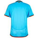 Rear view of a light blue Deutschland Rugby 7s Away Jersey by Macron with black, red, and yellow trim on the sleeves and collar.