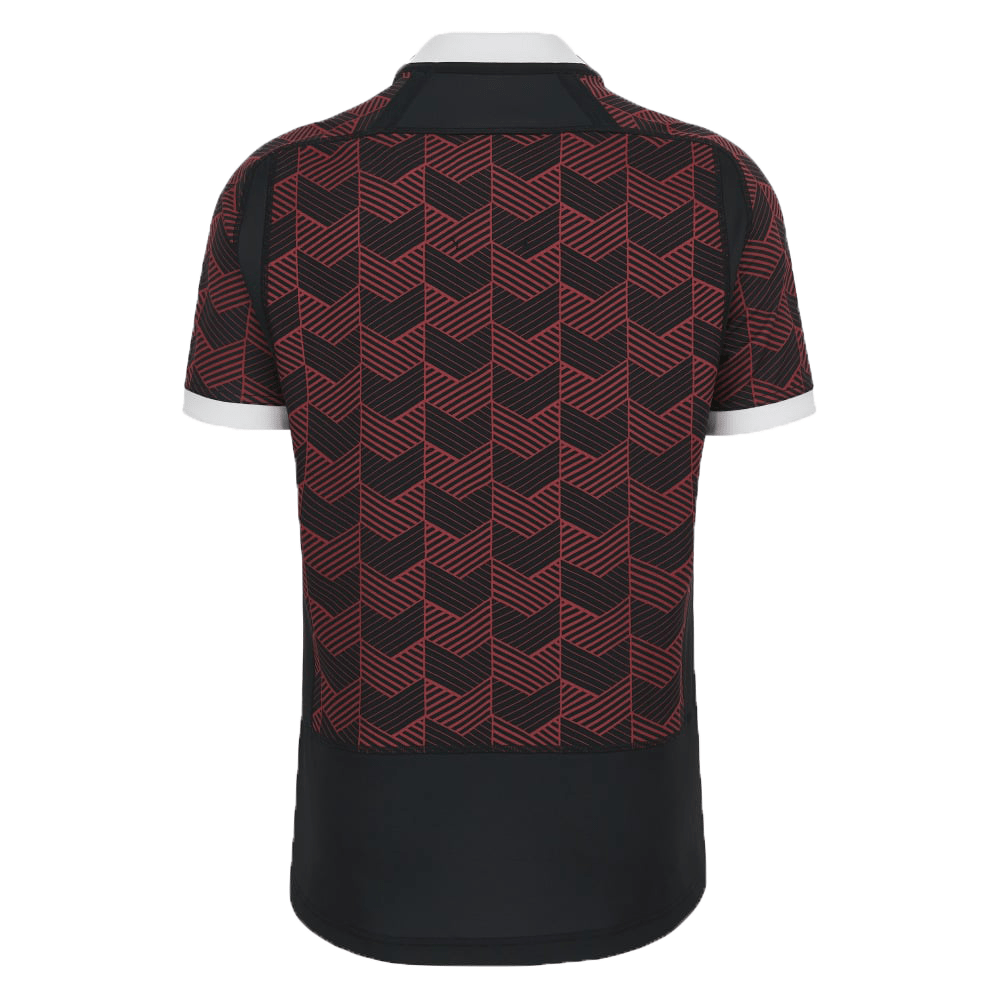 A black and red Macron Wales Rugby Union 23/24 Training Jersey with a chevron pattern.