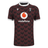 The Macron Wales Rugby Union 23/24 Training Jersey is red and black with the Macron logo on it.