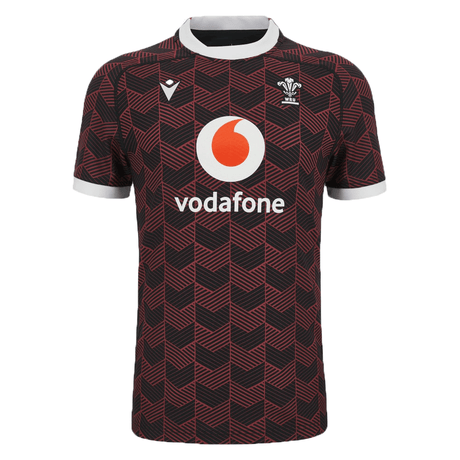 The Macron Wales Rugby Union 23/24 Training Jersey is red and black with the Macron logo on it.