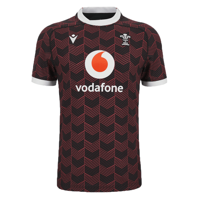 The Macron Wales Rugby Union 23/24 Training Jersey is red and black with the Macron logo on it.