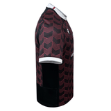 A Macron Wales Rugby Union 23/24 Training Jersey with a checkered pattern.