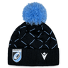 Black and blue Cardiff Blues Pom Pom Beanie 23/24 by Macron with a Cardiff Rugby logo patch and a blue pom-pom on top.