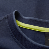 Close-up of the collar on the Ireland 26/27 Summer Tour Team Cotton T-Shirt by Canterbury in navy, showcasing a visible yellow inner trim and partial black label.