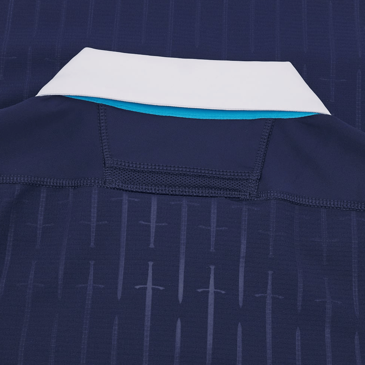 Close-up of the back of the Scotland Authentic Home Jersey 24/25 by Macron, featuring a white collar, blue lining, and a subtle sword pattern design.