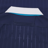 Close-up of the back of the Scotland Authentic Home Jersey 24/25 by Macron, featuring a white collar, blue lining, and a subtle sword pattern design.