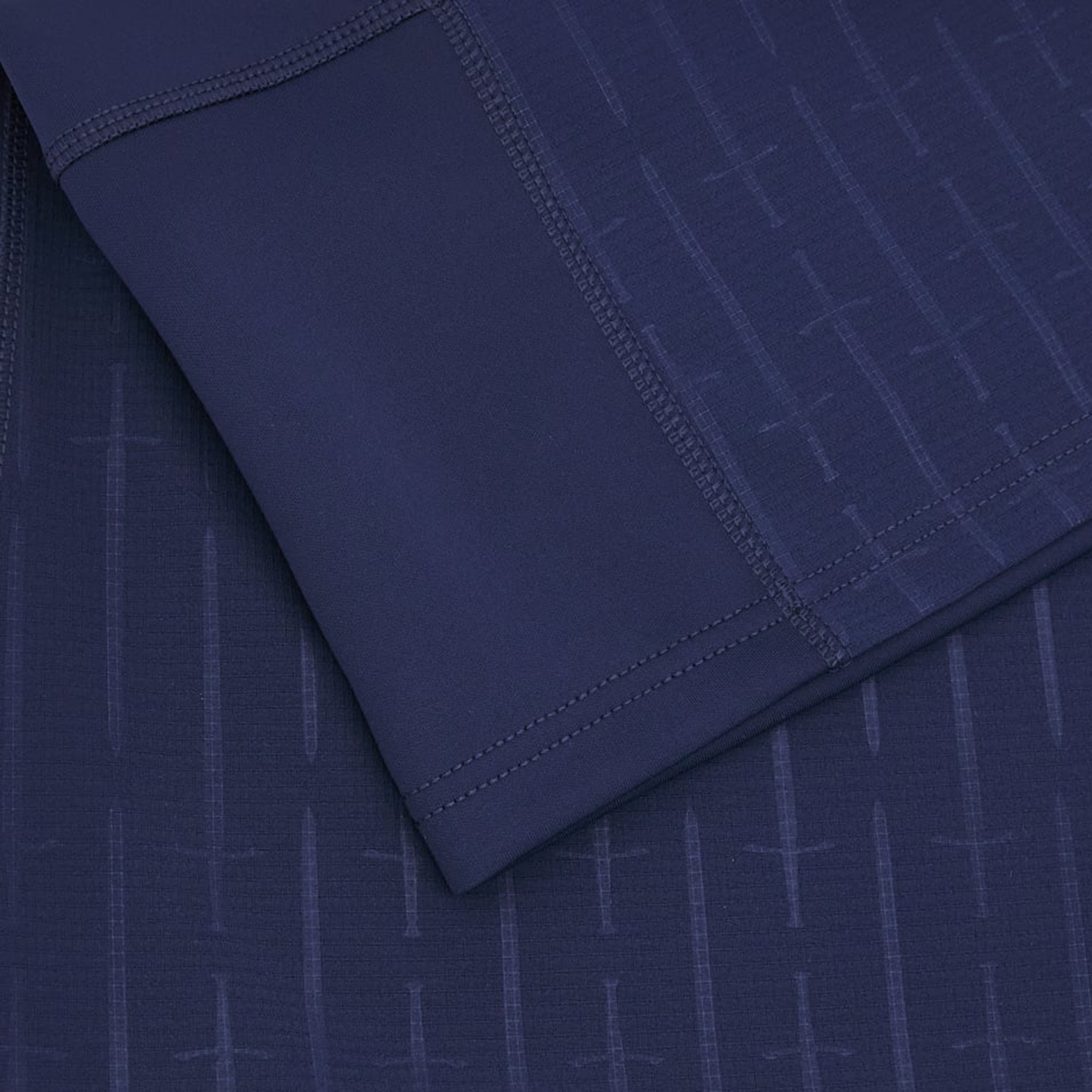 Close-up of the Scotland Authentic Home Jersey 24/25 by Macron in blue, showcasing intricate stitched detailing and a subtle sword pattern.