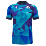 A Scotland Blue Training Jersey 24/25 by Macron, featuring a blue and teal geometric pattern with the Scotland logo on the left chest and a white Macron logo on the right chest.