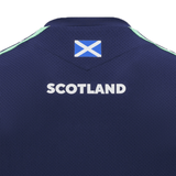 A close-up of the back of the Scotland Training Shirt 24/25 by Macron shows "Scotland" written in white, a small Scottish flag above it, and breathable mesh inserts for added comfort.
