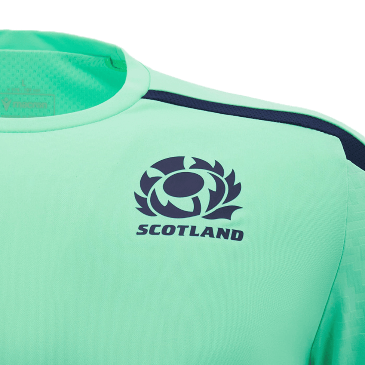 Close-up of a teal Scotland Training Shirt 24/25 by Macron featuring the word "Scotland" and a thistle emblem in navy blue on the chest, enhanced with breathable mesh inserts for added comfort.