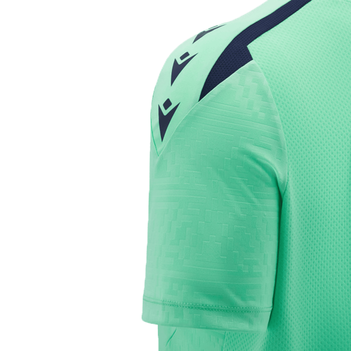 Close-up of the shoulder and sleeve of a light green Scotland Training Shirt 24/25 by Macron, featuring black logos, breathable mesh inserts, and textured fabric.