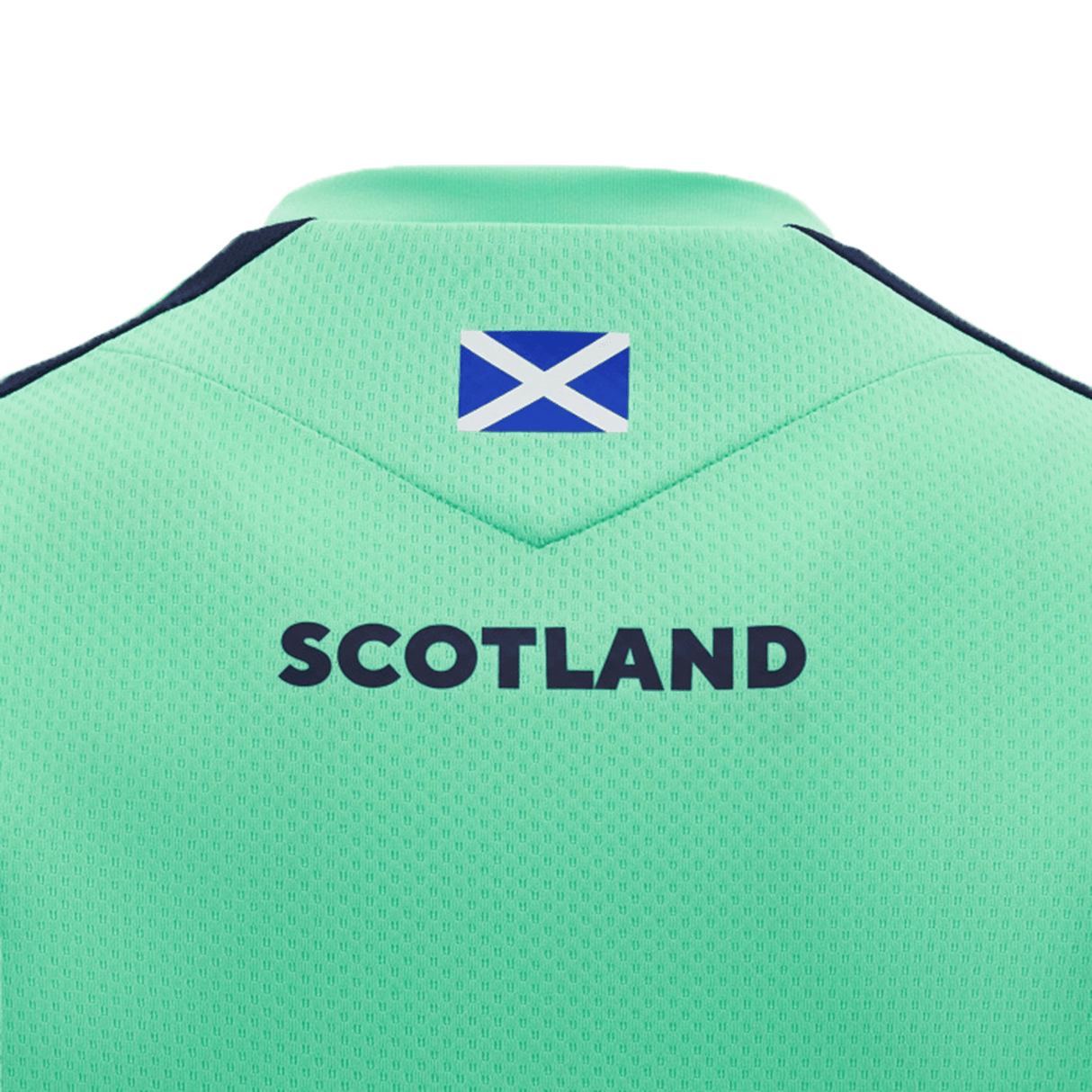 The upper back of the Scotland Training Shirt 24/25 by Macron, crafted by Macron, showcases a small Scottish flag near the collar with "Scotland" boldly printed below it. The breathable mesh fabric ensures comfort during intense training sessions.