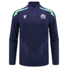 The Scotland 1/4 Zip Training Top 24/25 by Macron is a navy blue long-sleeve sports jersey with light blue shoulder accents, showcasing the Scotland Rugby Union emblem along with the Macron logo on the front.