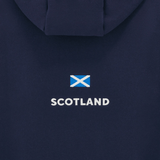 The Scotland Travel Hoodie 24/25 by Macron is a navy travel hoody featuring the Scottish flag with "Scotland" printed below, perfect for rugby fans and adventurers alike.