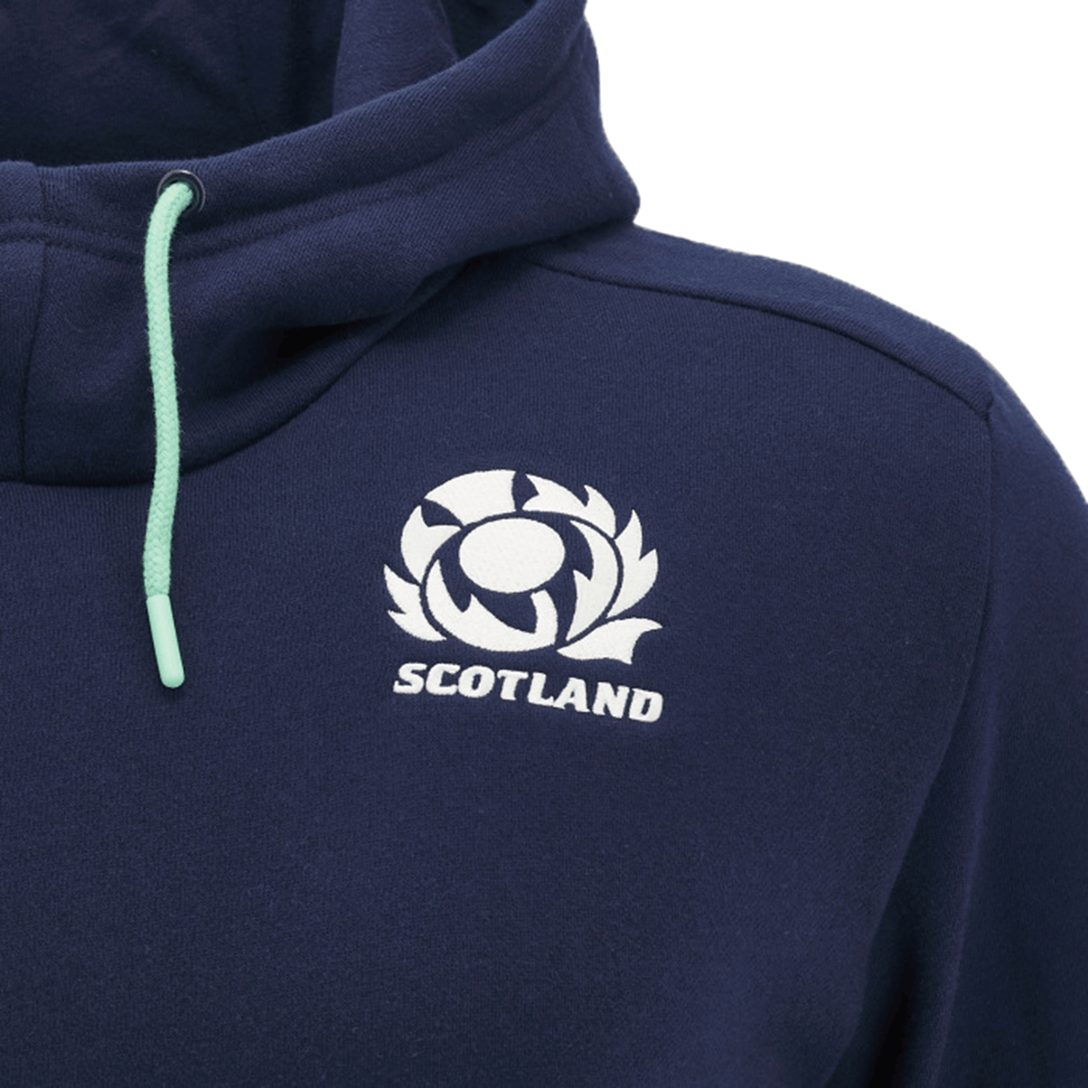 Close-up of the Scotland Travel Hoodie 24/25 by Macron, featuring a dark blue design with a white emblem showcasing a stylized thistle and the word "Scotland" printed below it. A green drawstring adds an extra touch. Perfect for any Scotland Rugby Union fan, this hoodie embodies your pride in style.