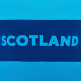 The Scotland Block Leisure Tee 24/25 by Macron is a blue and navy tee featuring the word "Scotland" in bold white letters across the chest, making it perfect for avid supporters of Scotland Rugby.