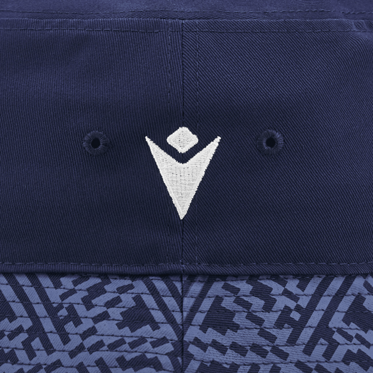 Close-up of the Scotland Bucket Hat 24/25 by Macron, featuring a navy blue design with a white 3D embroidered Scotland Rugby Union crest prominently centered above dual ventilation holes, and finished with a geometric patterned band at the bottom.