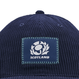 Introducing the Scotland Dad Cap 24/25 by Macron, a stylish blue cap with a ribbed texture. It showcases a central patch featuring a rugby ball within a thistle and the word "SCOTLAND" beneath it. Ideal for showing your support for Scotland Rugby Union!