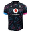The Wales 24/25 Pathway Away Jersey by Macron showcases geometric blue and pink triangles, a Vodafone logo, and a dragon crest with "WRU" on the upper right. This stylish jersey exemplifies the timeless design of a classic Macron jersey.