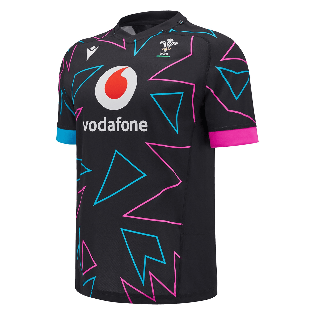 The Wales Rugby Union 24/25 Pathway Away Jersey by Macron features a black design with abstract blue and pink geometric patterns, prominently displaying the Vodafone logo and crest on the chest. This piece by Macron embodies the essence of a modern Welsh replica jersey with contemporary style.