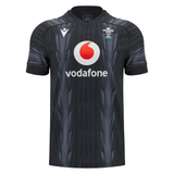 The Wales 24/25 Training Jersey by Macron, in black, features a subtle design alongside the Vodafone logo and the Wales Rugby emblem, capturing the essence of a true Wales Training Jersey.
