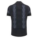 Back view of a Macron Wales 24/25 Training Jersey featuring a black and gray pattern, with short sleeves and a collar.