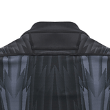 Close-up of the back of a black and gray patterned jacket with a standing collar, reminiscent of the sleek design of the Wales 24/25 Training Jersey by Macron.