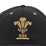 New Arrival: The Wales 24/25 Baseball Cap by Macron displays the legendary gold emblem of the Welsh Rugby Union, showcasing three feathers and the text "WRU.