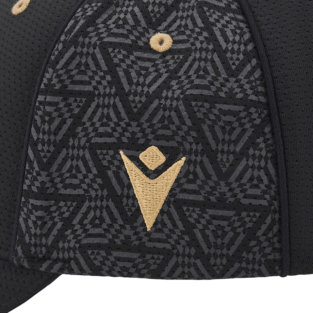 Close-up of the Wales 24/25 Baseball Cap by Macron featuring a geometric pattern and a gold embroidered symbol on the side.