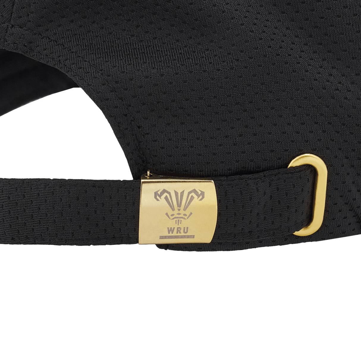 A close-up view of the adjustable strap on the Wales 24/25 Baseball Cap by Macron showcases a gold metal clasp adorned with the WRU logo. Recently released by Macron, this chic accessory combines both elegance and practicality.