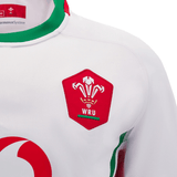 Close-up of a white Wales 24/25 6 Nations Replica Away Jersey by Macron, adorned with the WRU emblem and featuring red and green accents on the collar and sides. This authentic rugby shirt, meticulously crafted for dedicated fans, showcases exceptional detail.