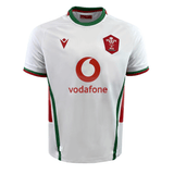 This Wales 24/25 6 Nations Replica Away Jersey by Macron is designed in white with red and green accents. It prominently displays the Vodafone logo in the center and features a bold red crest with a white emblem on the left chest, perfectly crafted by Macron for rugby fans.