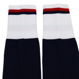 The USA Rugby 24/25 Player Home Socks by Macron feature navy blue with white cuffs and red and black stripes, inspired by classic USA Rugby home socks and designed for top player performance.