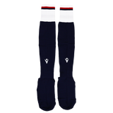 The USA Rugby 24/25 Replica Home Socks by Macron feature navy blue with white cuffs and red and navy stripes at the top, inspired by USA Rugby socks, shown on a plain white background.