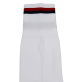 The Youth USA Rugby 24/25 Player Away Socks by Macron are white youth rugby socks with a ribbed cuff and navy blue and red stripes—ideal for fans of Youth USA Rugby.