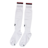 Inspired by official USA Rugby socks, the Macron USA Rugby 24/25 Replica Away Socks feature black and red stripes atop long white athletic socks, shown laid flat on a white background.