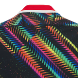 Close-up of the Gloucester 25/26 Replica Training Jersey by Macron, showcasing a vibrant geometric pattern with diagonal lines and chevrons, topped off with a striking red collar.