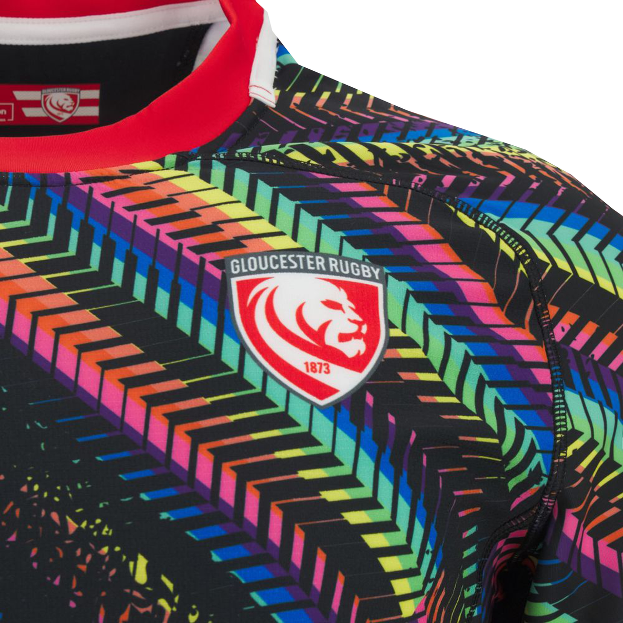Close-up of the Gloucester 25/26 Replica Training Jersey by Macron, highlighting its colorful geometric design and the iconic Gloucester Rugby crest with a lion and 1873.