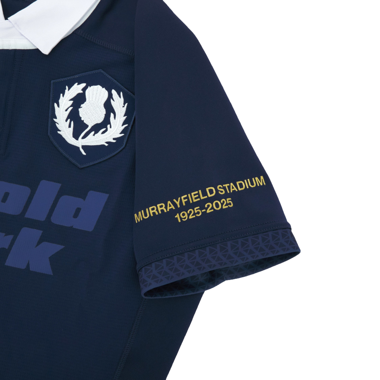 Close-up of the Scotland Rugby Union 1925 100th Anniversary Authentic Home Jersey by Macron, featuring a navy design, white thistle emblem, and "Murrayfield Stadium 1925-2025" in yellow on the sleeve, marking the centenary.
