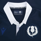 Close-up of the Scotland Rugby Union 1925 100th Anniversary Authentic Home Jersey by Macron, featuring a white collar, thistle emblem, and navy/white logos, celebrating 100 years of Murrayfield.