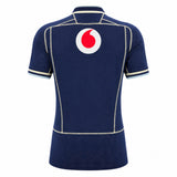 Navy blue short-sleeve jersey shown from the back with white and beige trim and a large red and white circular logo near the top—this is the Scotland SRU 26/27 Authentic Matchday Home Jersey by Macron, inspired by the official Scotland Rugby home kit.