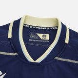 Close-up of the Scotland SRU 26/27 Authentic Matchday Home Jersey by Macron in dark blue, highlighting the collar with the Macron brand label, "SCOTLAND" text, and Ecoperformance-System tag—genuine matchday shirt details.