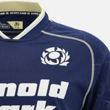 Close-up of the Scotland SRU 26/27 Replica Home Jersey by Macron in navy blue, showcasing the iconic thistle emblem and bold white "Arnold Clark" sponsor text on the front. This official jersey from Macron captures every detail of the classic Scotland rugby design.