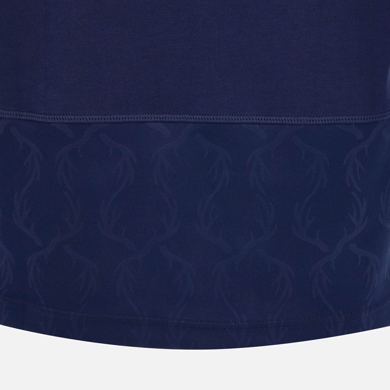 Close-up of the Scotland SRU 26/27 Cotton Replica Home Jersey by Macron in dark blue, highlighting the subtle deer antler pattern near the hem and visible stitching above this patterned section.