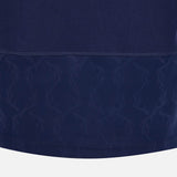 Close-up of the Scotland SRU 26/27 Cotton Replica Home Jersey by Macron in dark blue, highlighting the subtle deer antler pattern near the hem and visible stitching above this patterned section.