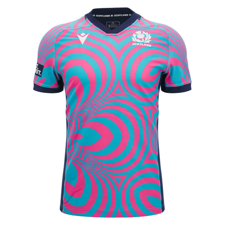 The Scotland SRU 26/27 Replica Training Jersey by Macron features blue and pink concentric circle patterns, a navy collar and sleeve trim, and prominently displays the Scotland Rugby logo on the chest. Crafted by Macron, it’s perfect for fans looking for an authentic Scotland Rugby Jersey look.