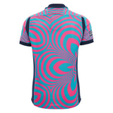 Back view of the Scotland SRU 26/27 Replica Training Jersey by Macron, a short-sleeve polo shirt featuring a bright pink and teal geometric spiral pattern with navy blue trim on the collar, sleeves, and sides—a vibrant design inspired by iconic Scotland Rugby style from Macron.