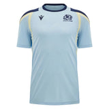The Scotland SRU 26/27 Player Training Shirt by Macron is a light blue rugby training top with navy and yellow accents, featuring both the Scotland Rugby logo and the Macron brand logo on the chest, shown against a plain background.
