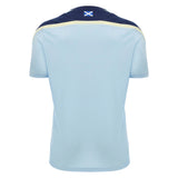 Back view of the Scotland SRU 26/27 Player Training Shirt by Macron in light blue, featuring short sleeves, dark blue and yellow accents, and a small Scottish flag below the collar.